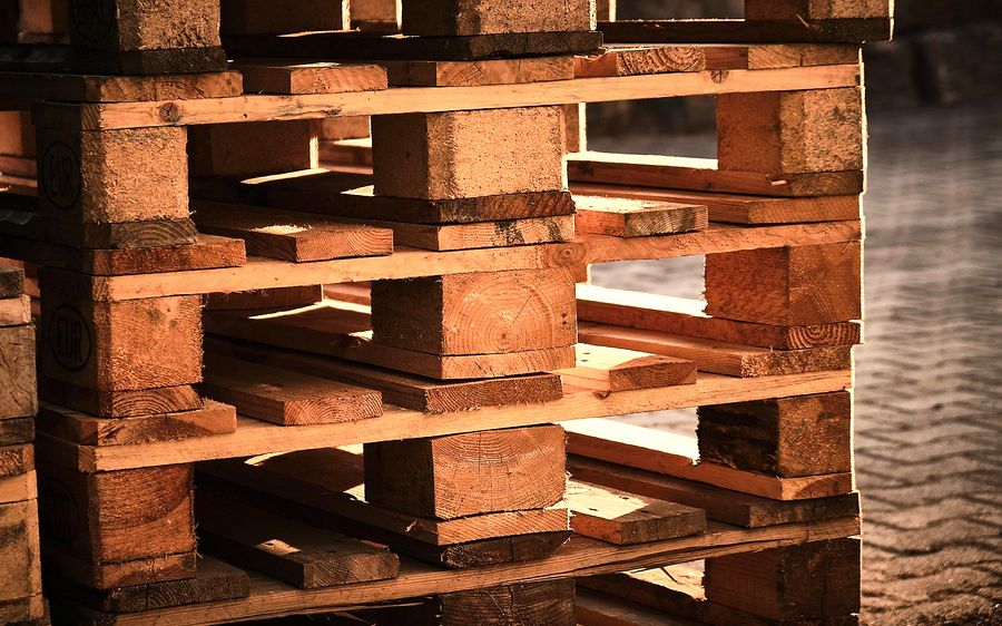 Used Euro pallets stacked in a yard
